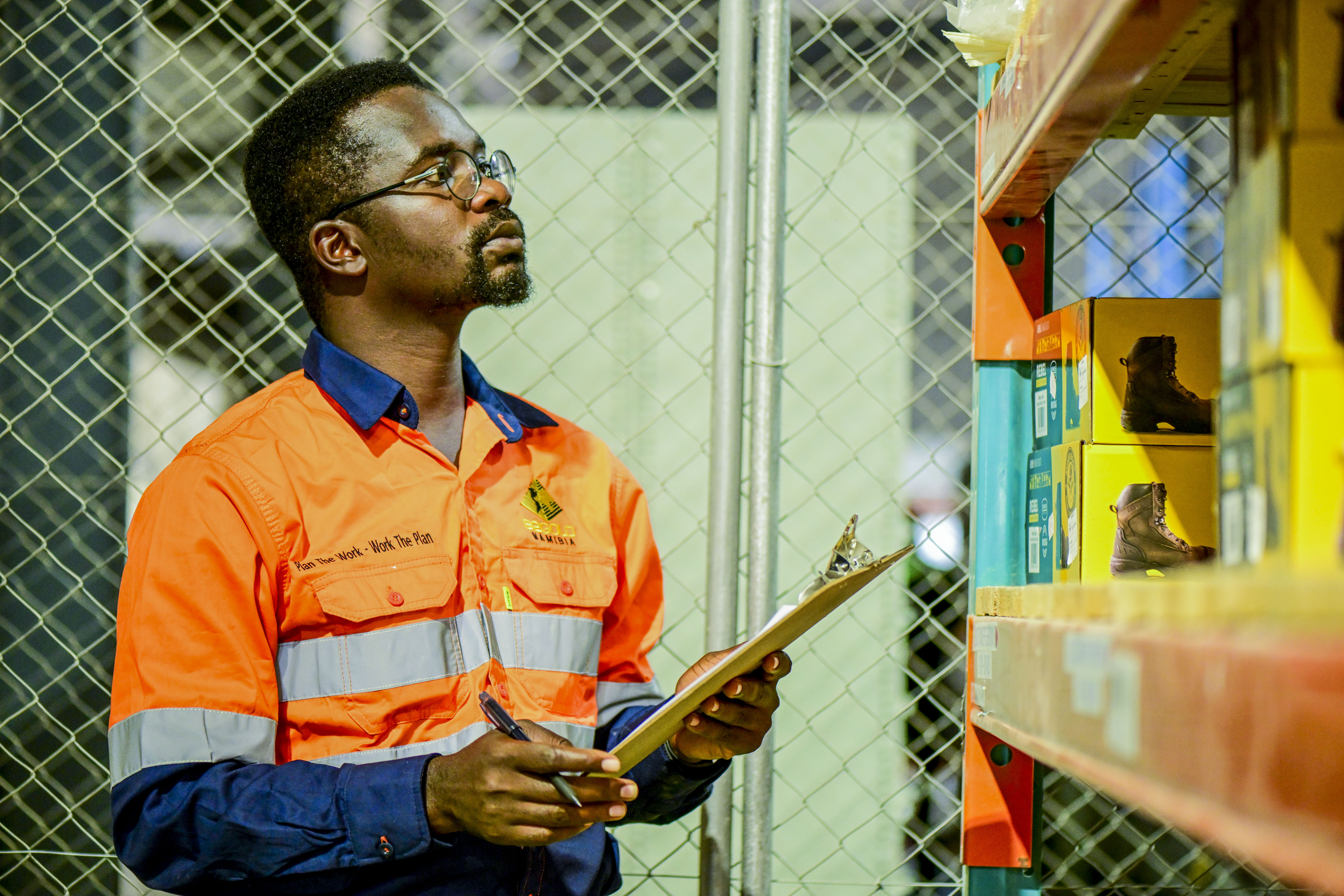 Solar plant worker inspects electrical control systems in a facility.