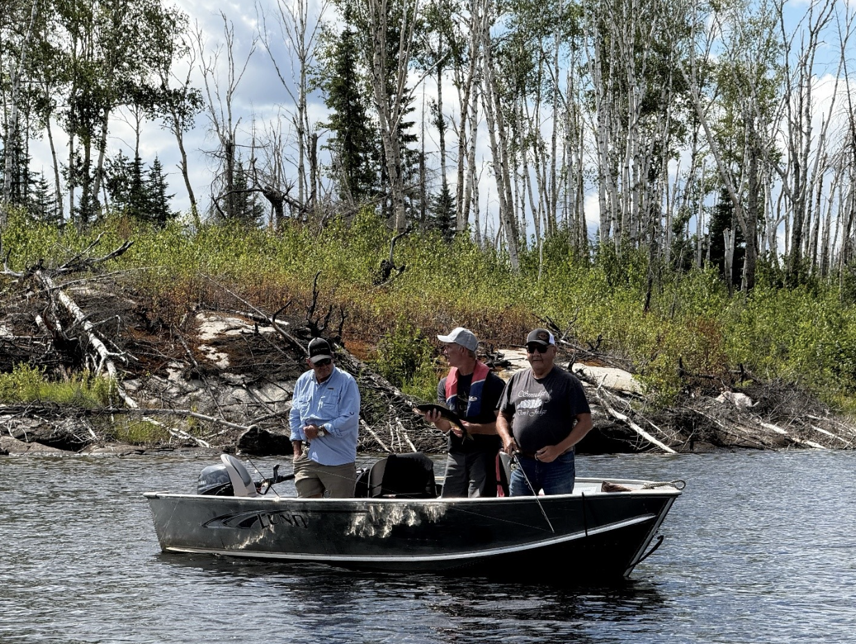 Paul Rollinson, Ian Russell and Chief Petiquan search for Walleye fish